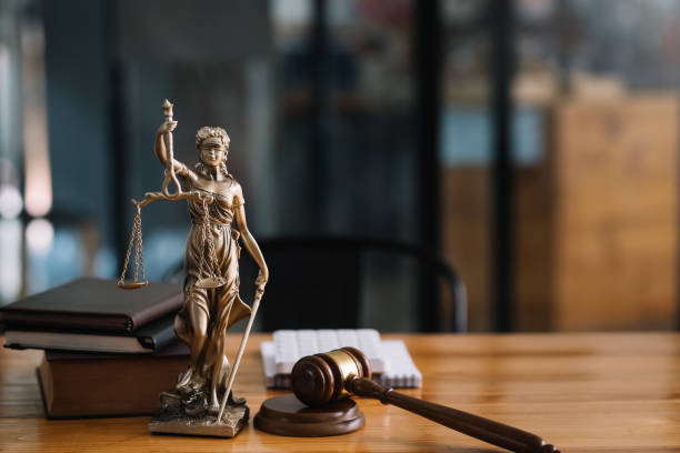 Statue of lady justice on desk of a judge or lawyer. write