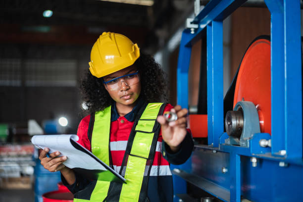 safty 9 Industrial Engineers or Foreman inspecting and check up machine at factory machines.