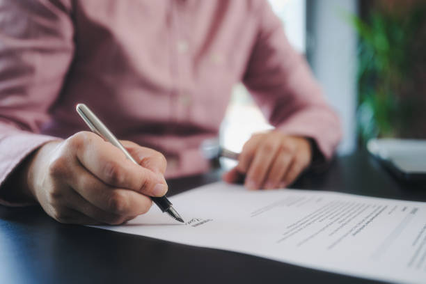 businesswoman signing an official document write