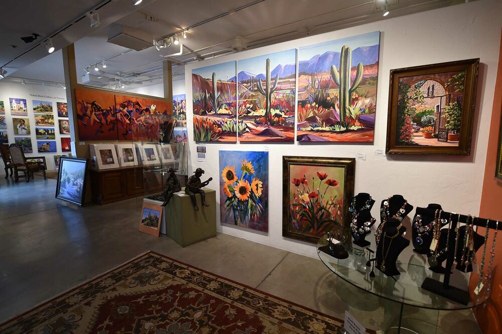 Art Galleries Near Me | Fine Art, Paintings & Unique Collections Interior of a vibrant art gallery featuring colorful desert landscape paintings, floral artwork, framed pieces, sculptures, and handcrafted jewelry displays, showcasing a creative space for visitors searching for Art Galleries Near Me.